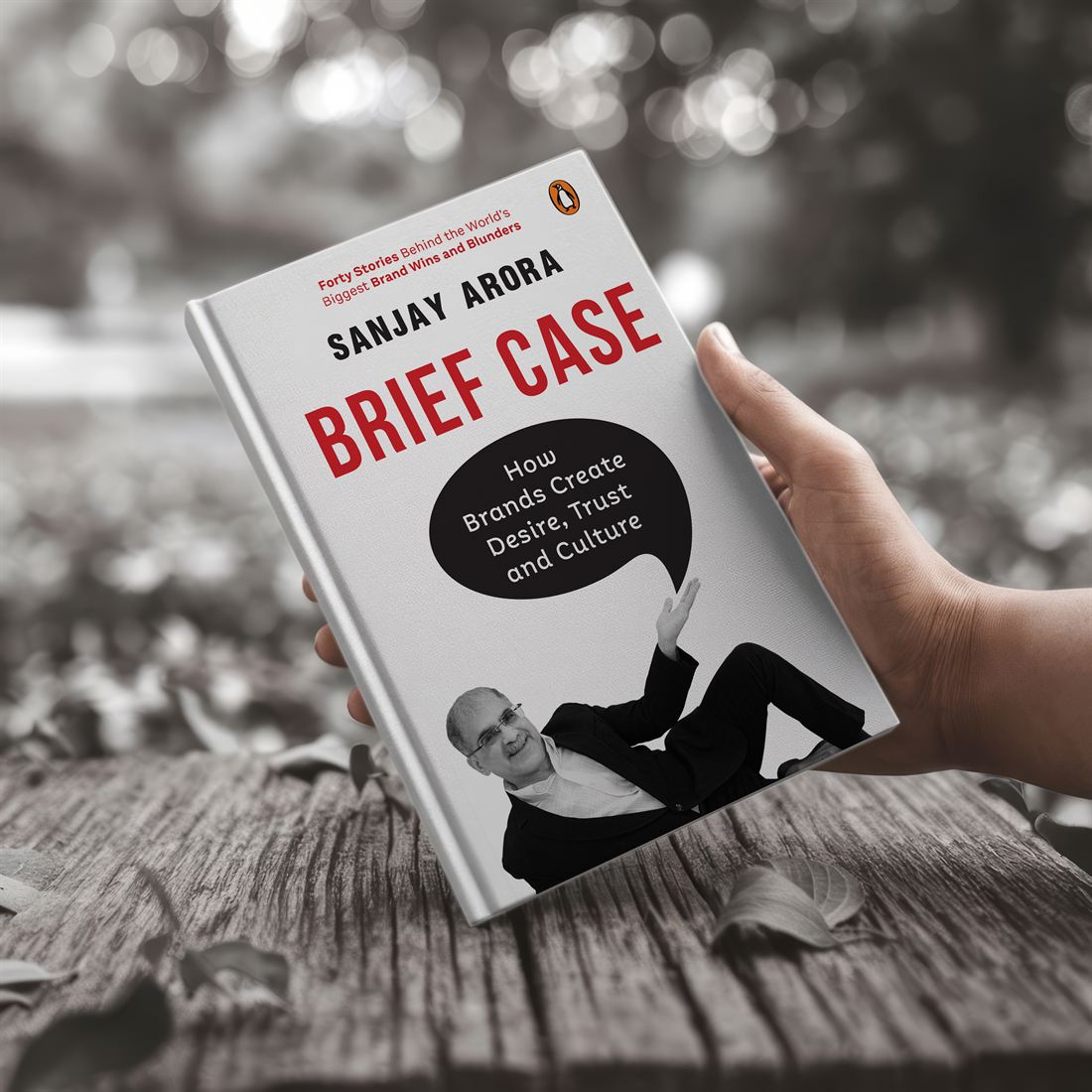 A copy of Brief Case by Sanjay Arora, held in one hand